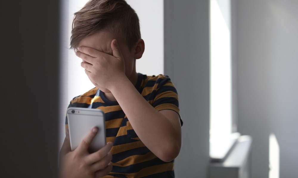 frightened-little-child-with-smartphone-indoors-danger-of-internet